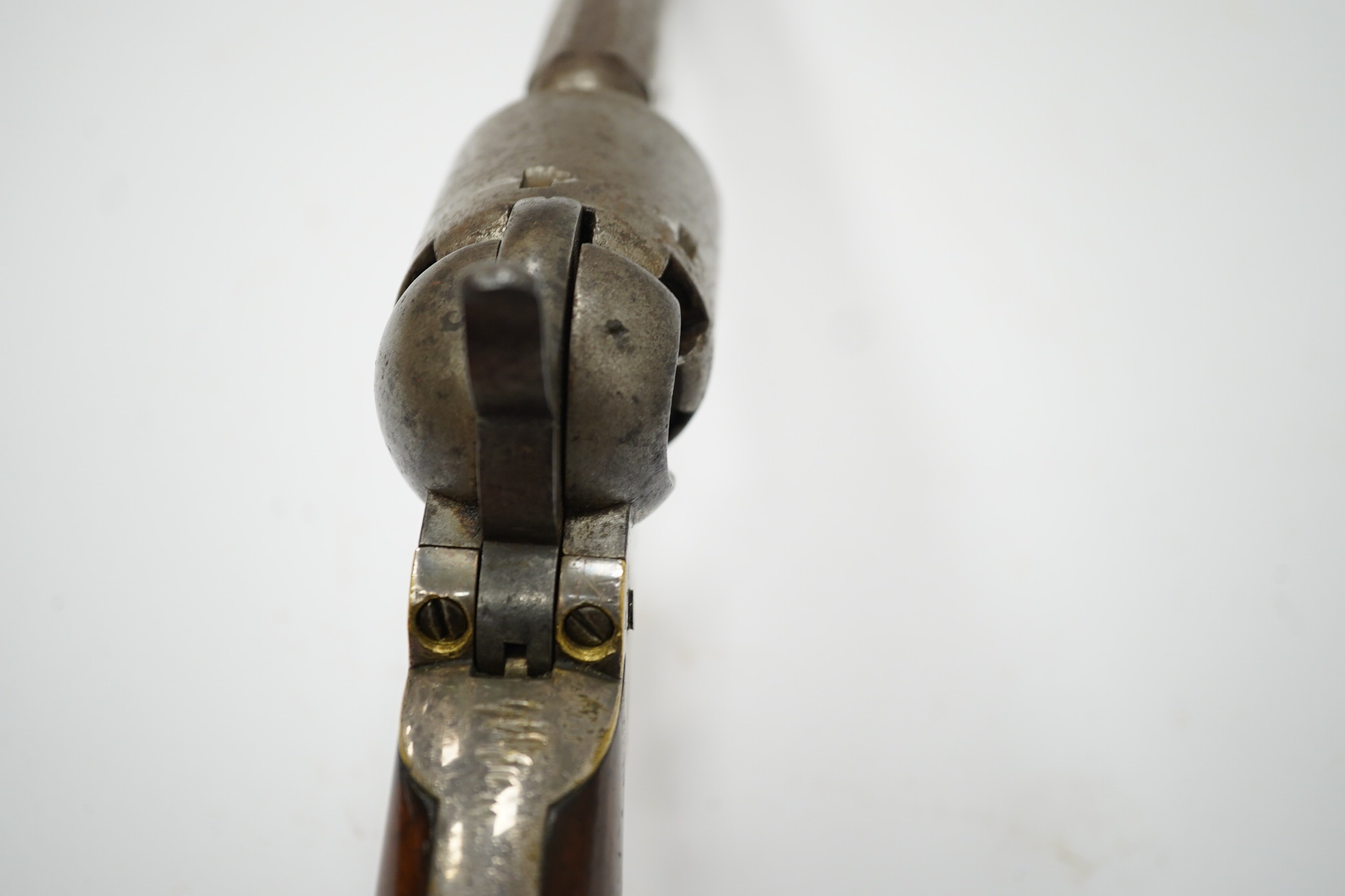 A six shot .36 Colt Navy single action percussion revolver, number 1875 (matching), regulation under lever rammer, signed barrel, roll engraved cylinder, brass mounts with traces of plating and single piece walnut grip,